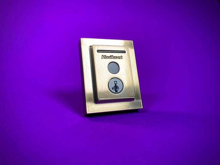 The Kwikset Halo Touch fingerprint-scanning smart lock against a purple backdrop.